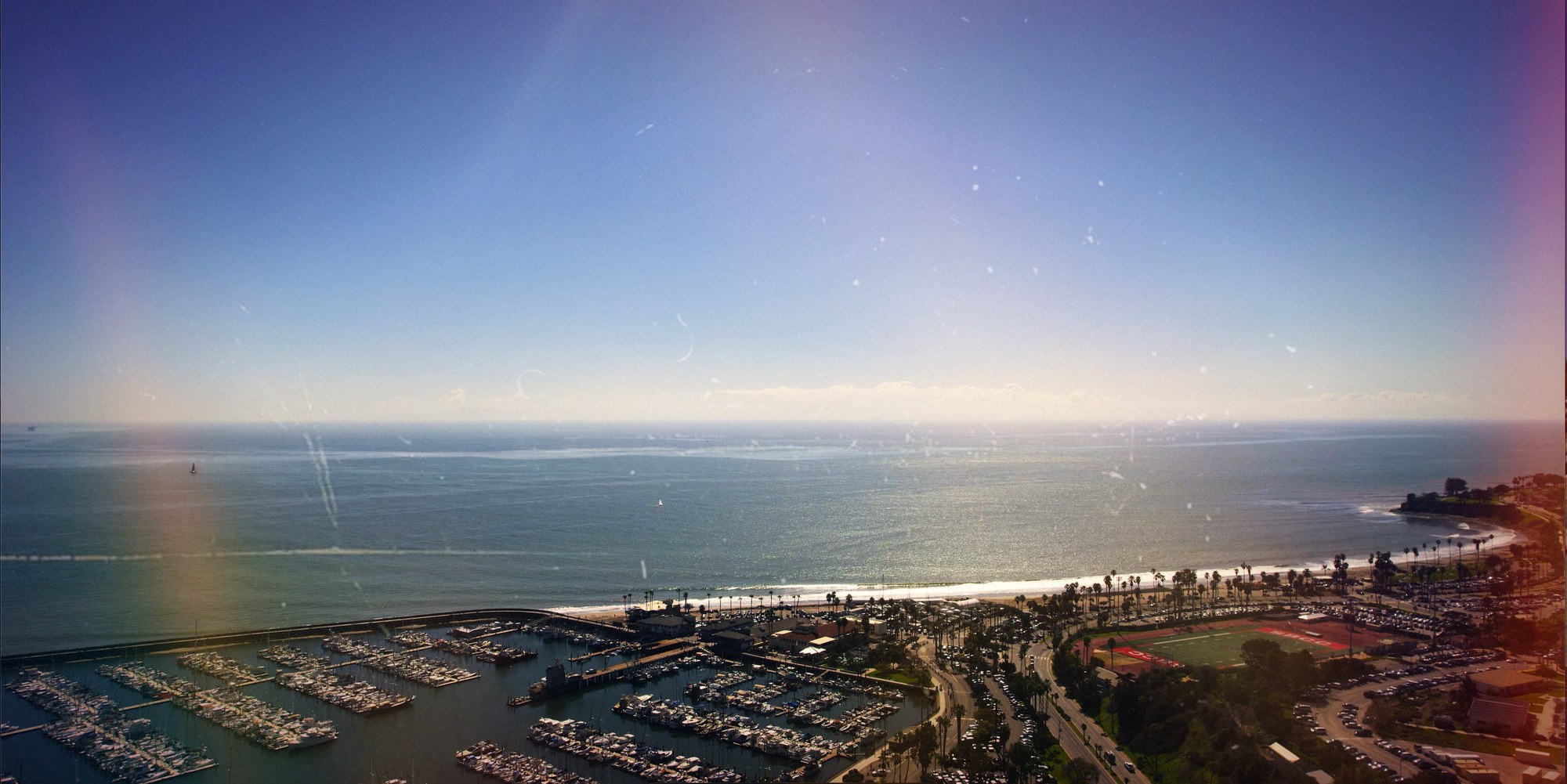 Cinematic aerial view of the Santa Barbara coastline, marina, and Pacific Ocean